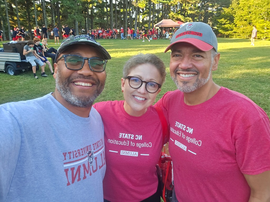 Dr. AJ Jaeger standing with two former students, Dr. Jairo McMican (left) and Dr. Abe Dones (right).